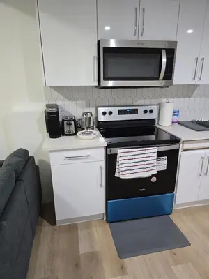 a kitchen with a stove and a microwave at Amazing 2-bedroom house with WiFi in Edmonton in Edmonton