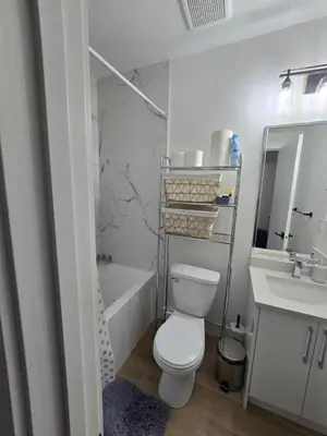 a white bathroom with a toilet and a sink at Amazing 2-bedroom house with WiFi in Edmonton in Edmonton