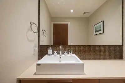 a bathroom with a white sink and a mirror at Fitzsimmons Walk 35 by Outpost Whistler in Whistler
