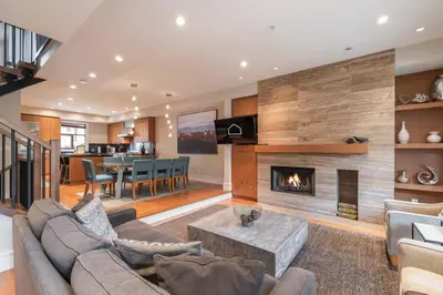 a living room with a couch and a fireplace at Fitzsimmons Walk 35 by Outpost Whistler in Whistler