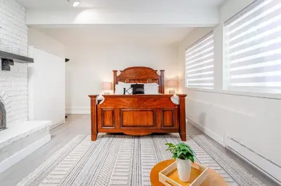 a bedroom with a wooden bed and a window at Spacious 3Bedrooms Family Getaway in North Vancouver in North Vancouver