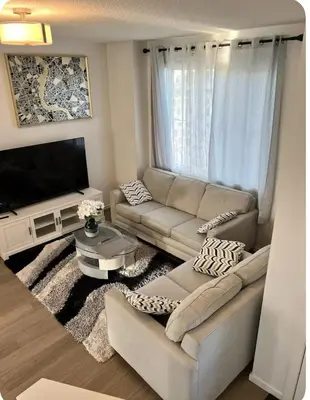 a living room with a couch and a tv at Bedroom in Southwest 2 in Edmonton