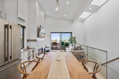 a kitchen and dining room with a table and chairs at Family-Friendly Beachside Bliss in Oyster Bay