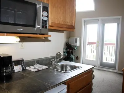 a kitchen with a sink and a microwave at Radium Chalet in Radium Hot Springs