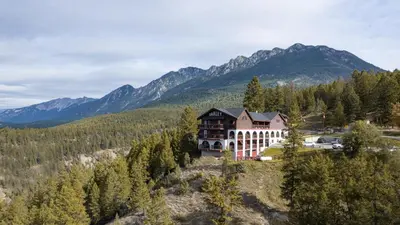 an aerial view of a large house in the mountains at Radium Chalet in Radium Hot Springs