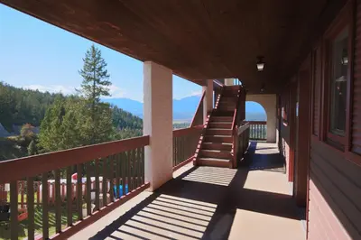 a balcony of a house with a view of the mountains at Radium Chalet in Radium Hot Springs