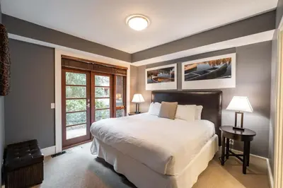 a bedroom with a large bed and a window at Fitzsimmons Walk 37 by Outpost Whistler in Whistler