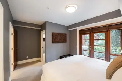 a bedroom with a large bed and a window at Fitzsimmons Walk 37 by Outpost Whistler in Whistler