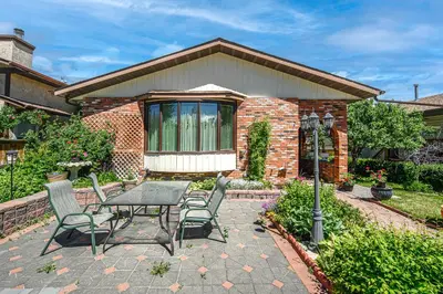 a patio with a table and chairs in front of a house at Centrally located 1 Bed 1 Bath Ensuite Cute Guest Suite Private Laundry Pet OK in Calgary