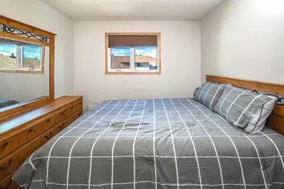 a bedroom with a bed and a window at Centrally located 1 Bed 1 Bath Ensuite Cute Guest Suite Private Laundry Pet OK in Calgary