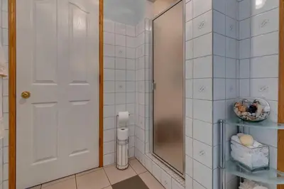 a bathroom with a shower and a glass door at Centrally located 1 Bed 1 Bath Ensuite Cute Guest Suite Private Laundry Pet OK in Calgary