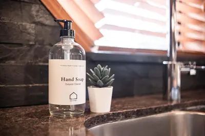 a bottle of hand soap sitting on a counter next to a sink at Foxglove 16 by Outpost Whistler in Whistler