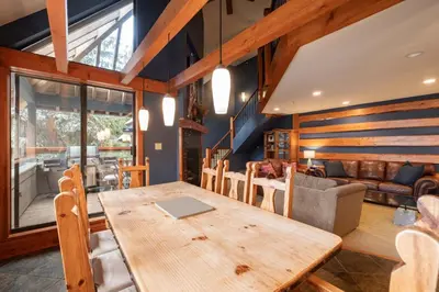 a dining room with a table and a couch at Foxglove 16 by Outpost Whistler in Whistler