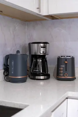 two coffeemakers sitting on a counter in a kitchen at 3BR 2BA Surrey Home | Quiet & Convenient in Surrey
