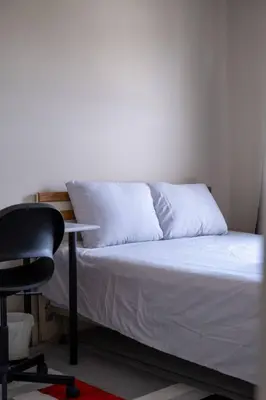 a bedroom with a bed with a desk and a chair at 3BR 2BA Surrey Home | Quiet & Convenient in Surrey