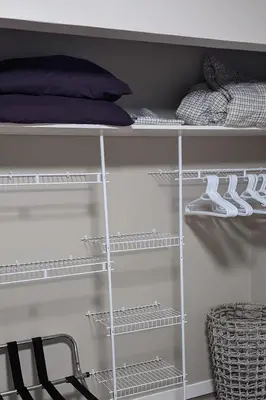 a closet with white shelves and a bed at Private SweetSuite 1 Bdrm Bathroom mini-kitchen in Kamloops