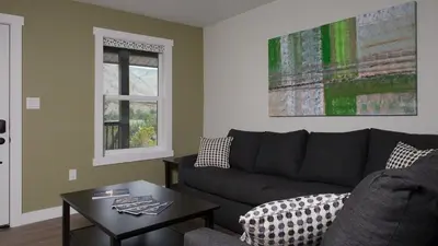 a living room with a couch and a table at Klippers Guest Suites in Cawston
