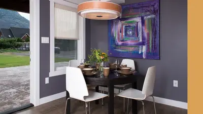 a dining room with a black table and white chairs at Klippers Guest Suites in Cawston