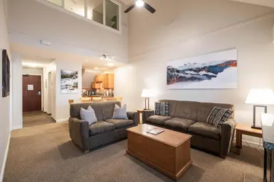a living room with two couches and a coffee table at Glacier Lodge 309 by Outpost Whistler in Whistler