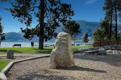 a rock statue in a park near the water at Coast Penticton Hotel in Penticton
