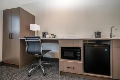 an office with a desk with a chair and a microwave at Coast Penticton Hotel in Penticton