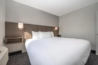 a large white bed in a hotel room at Coast Penticton Hotel in Penticton