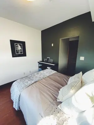 a bedroom with a large bed with white pillows at Sable Ridge Retreat in Radium Hot Springs
