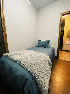 a bedroom with a bed with a gray blanket at Sable Ridge Retreat in Radium Hot Springs