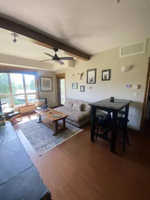 a living room with a couch and a table at Sable Ridge Retreat in Radium Hot Springs