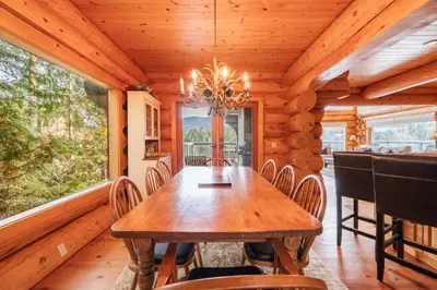 a dining room with a wooden table and chairs at Heron Chalet by Outpost Whistler in Whistler