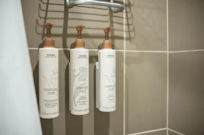 a group of three bottles on a rack in a bathroom at Lake Placid Lodge 18 by Outpost Whistler in Whistler