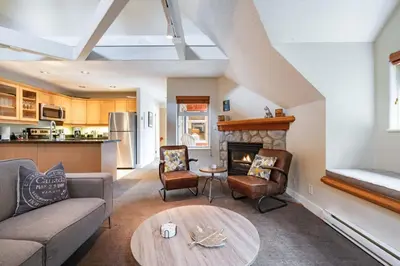 a living room with a couch and a fireplace at Lake Placid Lodge 18 by Outpost Whistler in Whistler