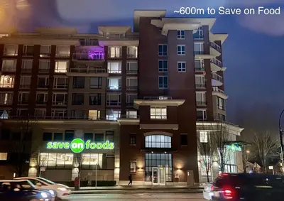 a building with a sign that says save on food at Private Entire Guest Suite, 1 min to bus stops to Downtown and major attractions in Vancouver