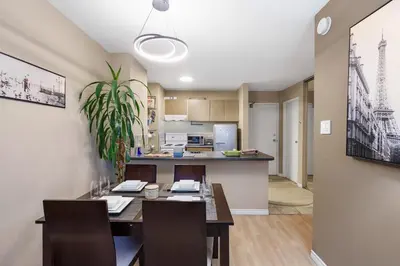 a dining room and kitchen with a table and chairs at Cozy Home in Downtown Minutes from Seawall in Vancouver