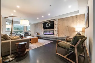 a living room with a couch and a tv at Le Chamois 508 by Outpost Whistler in Whistler