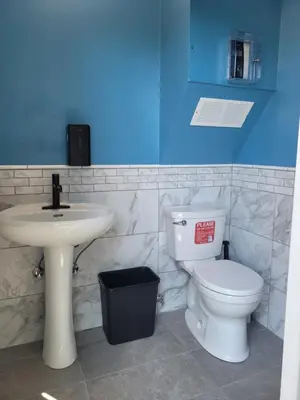 a bathroom with a white toilet and a sink at Gibsons Creek RV Resort and Campground in Gibsons