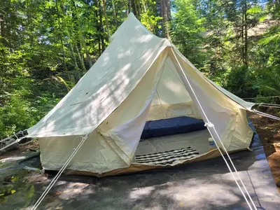 a tent in the middle of a forest at Gibsons Creek RV Resort and Campground in Gibsons