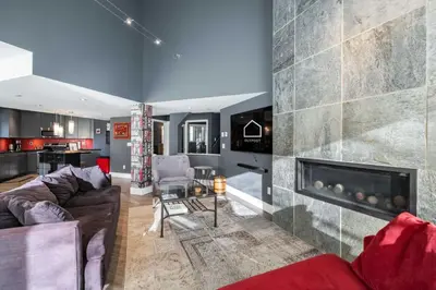 a living room with a couch and a fireplace at Lynx 204 by Outpost Whistler in Whistler