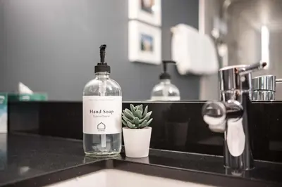 a bottle of liquid soap sitting on a kitchen counter at Lynx 204 by Outpost Whistler in Whistler