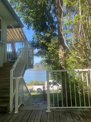 a view of the ocean from the porch of a house at West facing Waterfront Retreat with private beach, dock access & private buoy in Blind Bay
