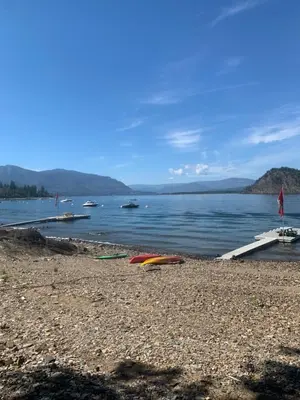 a beach with boats in a body of water at West facing Waterfront Retreat with private beach, dock access & private buoy in Blind Bay