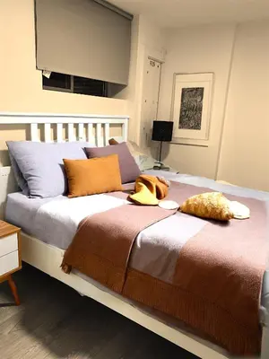 a bedroom with a large bed with pillows at 1Bd Modern Suite close to Langley Events Centre and Hwy1 in Langley