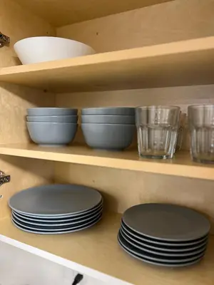 a shelf with plates and bowls on it at 1Bd Modern Suite close to Langley Events Centre and Hwy1 in Langley
