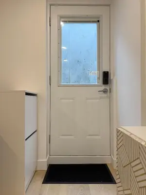 a white door in a kitchen with a window at 1Bd Modern Suite close to Langley Events Centre and Hwy1 in Langley