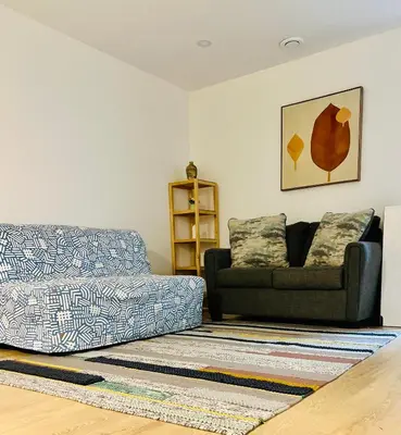 a living room with a couch and a chair at 1Bd Modern Suite close to Langley Events Centre and Hwy1 in Langley