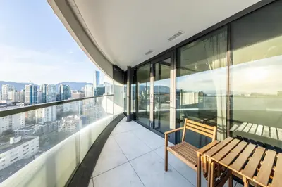 a bench on the balcony of a building at Brand New One-bedroom Apartment in Vancouver