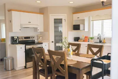 a kitchen with a table and chairs in a room at Cozy Calgary Hideaway in Calgary