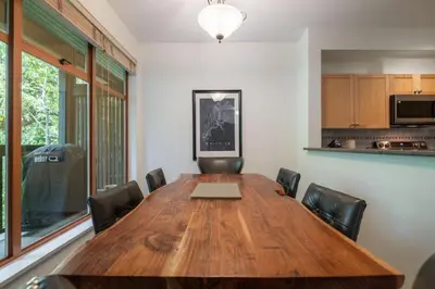 a conference room with a wooden table and chairs at Northstar 51 by Outpost Whistler in Whistler