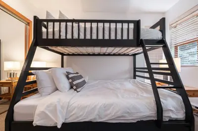 a couple of bunk beds in a room at Northstar 51 by Outpost Whistler in Whistler