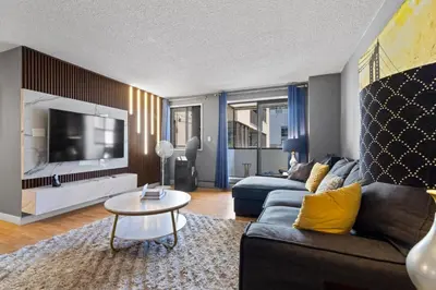 a living room with a couch and a tv at Modern 2 bedroom next to Stampede, 17th w Parking in Calgary